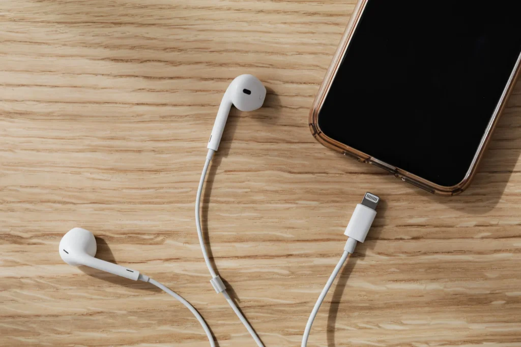 Earphones and a phone on a desk